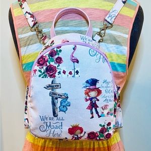 Mini Backpack in Alice in Wonderland with pink background. CraftyParrottDesigns